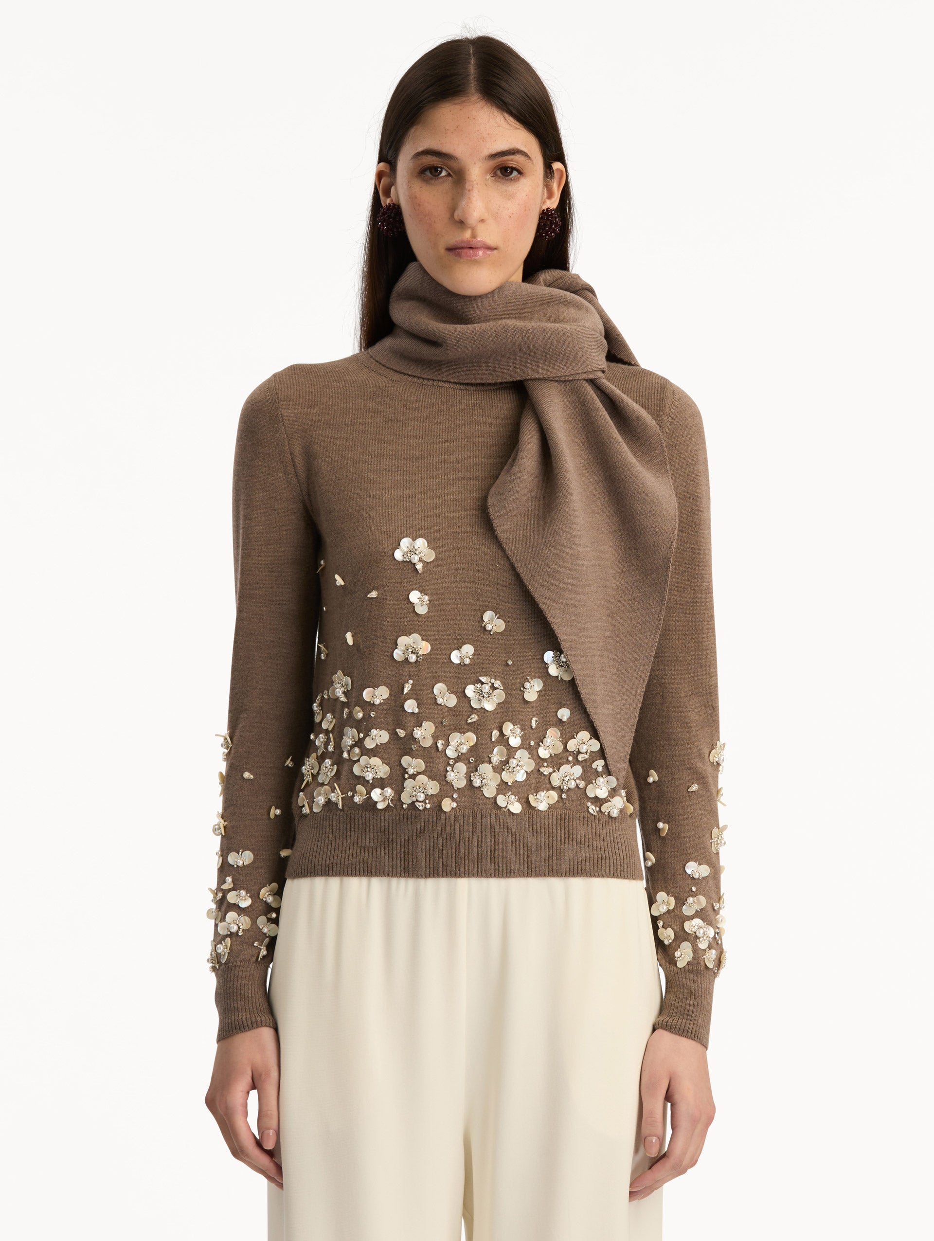 Brown Mother of Pearl Embroidered Pullover with Scarf featuring an attached draped scarf neckline and sequin floral embroidery along the hem and sleeves. Front View.