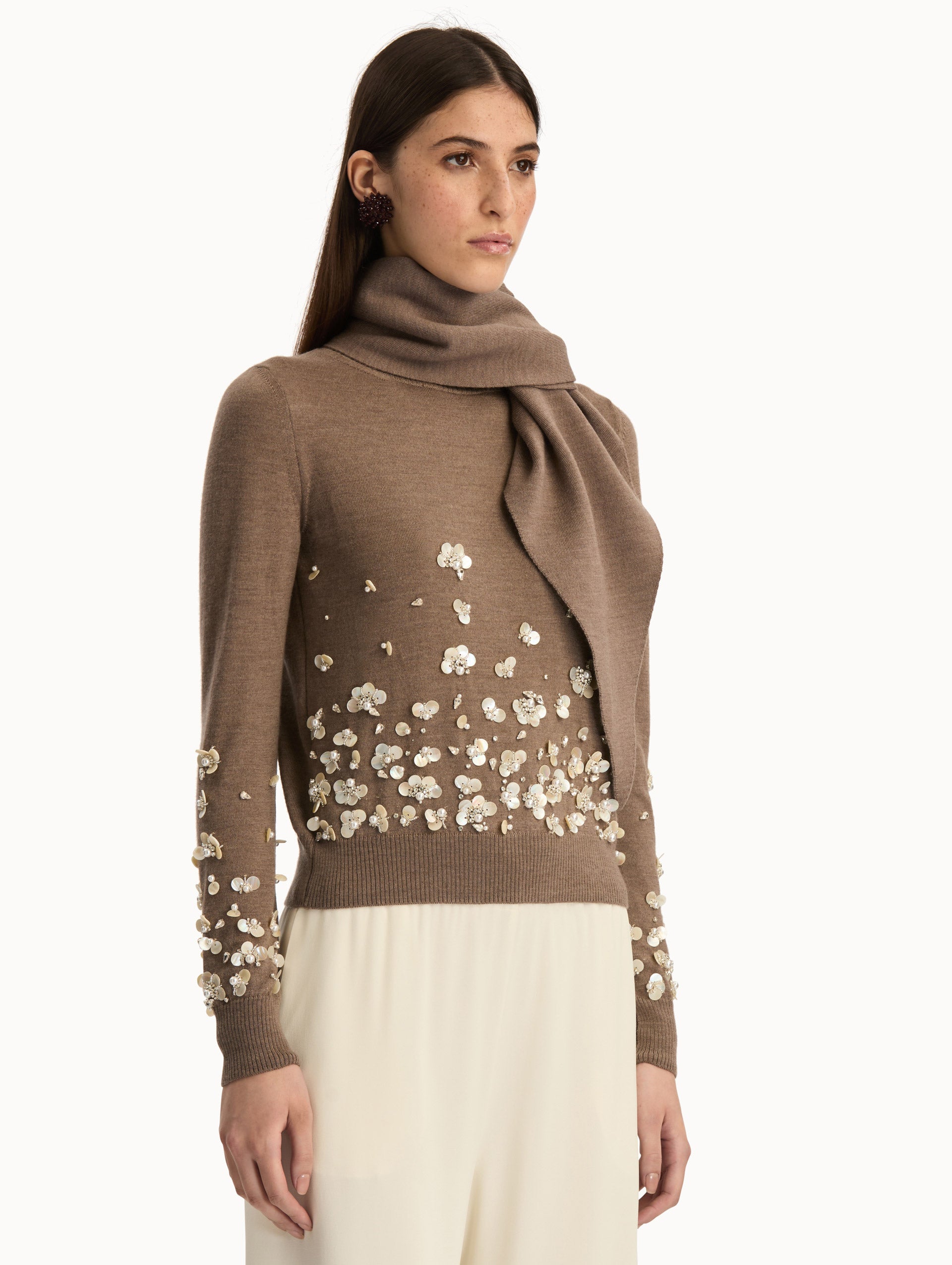 Brown Mother of Pearl Embroidered Pullover with Scarf featuring an attached draped scarf neckline and sequin floral embroidery along the hem and sleeves. Side View.