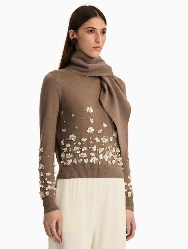 Brown Mother of Pearl Embroidered Pullover with Scarf featuring an attached draped scarf neckline and sequin floral embroidery along the hem and sleeves. Side View.