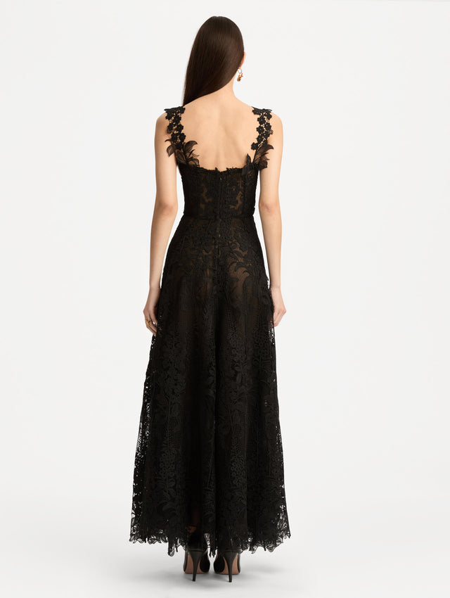Black Foxglove Guipure Cocktail Dress featuring a fitted bodice with structured cups, lace straps, and a sheer lace overlay skirt. Back View.