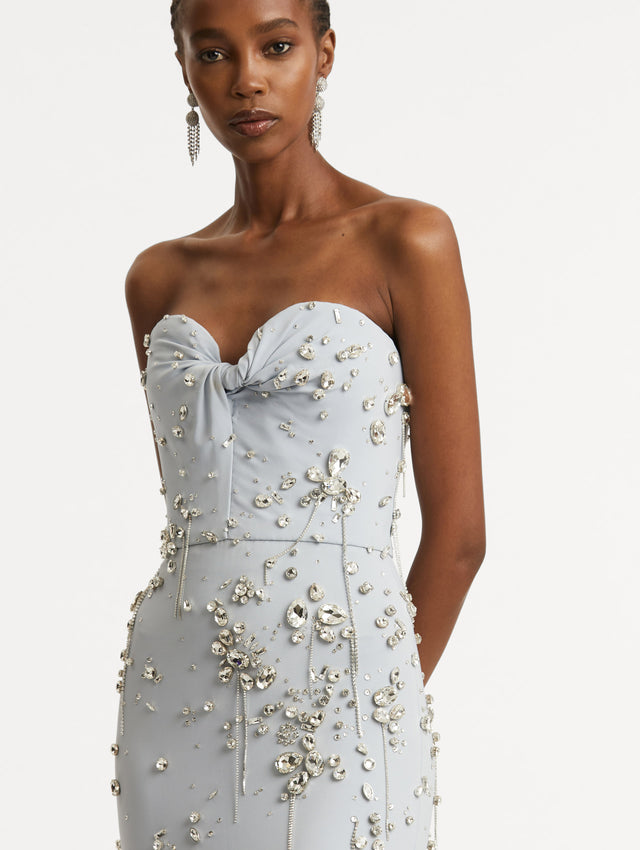 Zoomed in image of twist-detail on the sweetheart neckline with multi-dimensional stones scattered across the dress. 