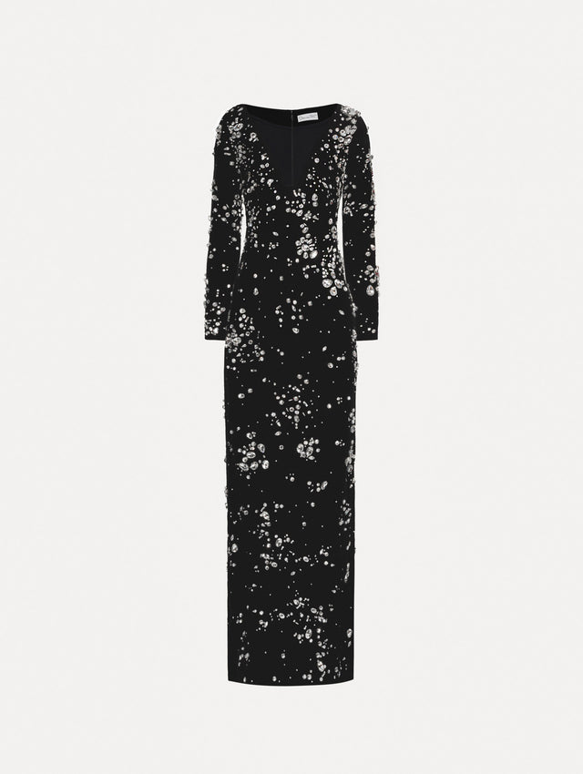 Long sleeve black gown with multi-dimensional stones scattered across the dress, features plunging V-neckline and column silhouette.