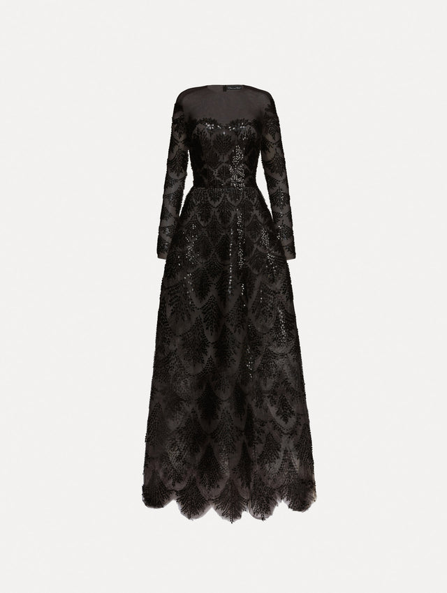 Black long sleeve gown with an illusion neckline and softly flared skirt. Features black sequin fern embroidery against the tulle base