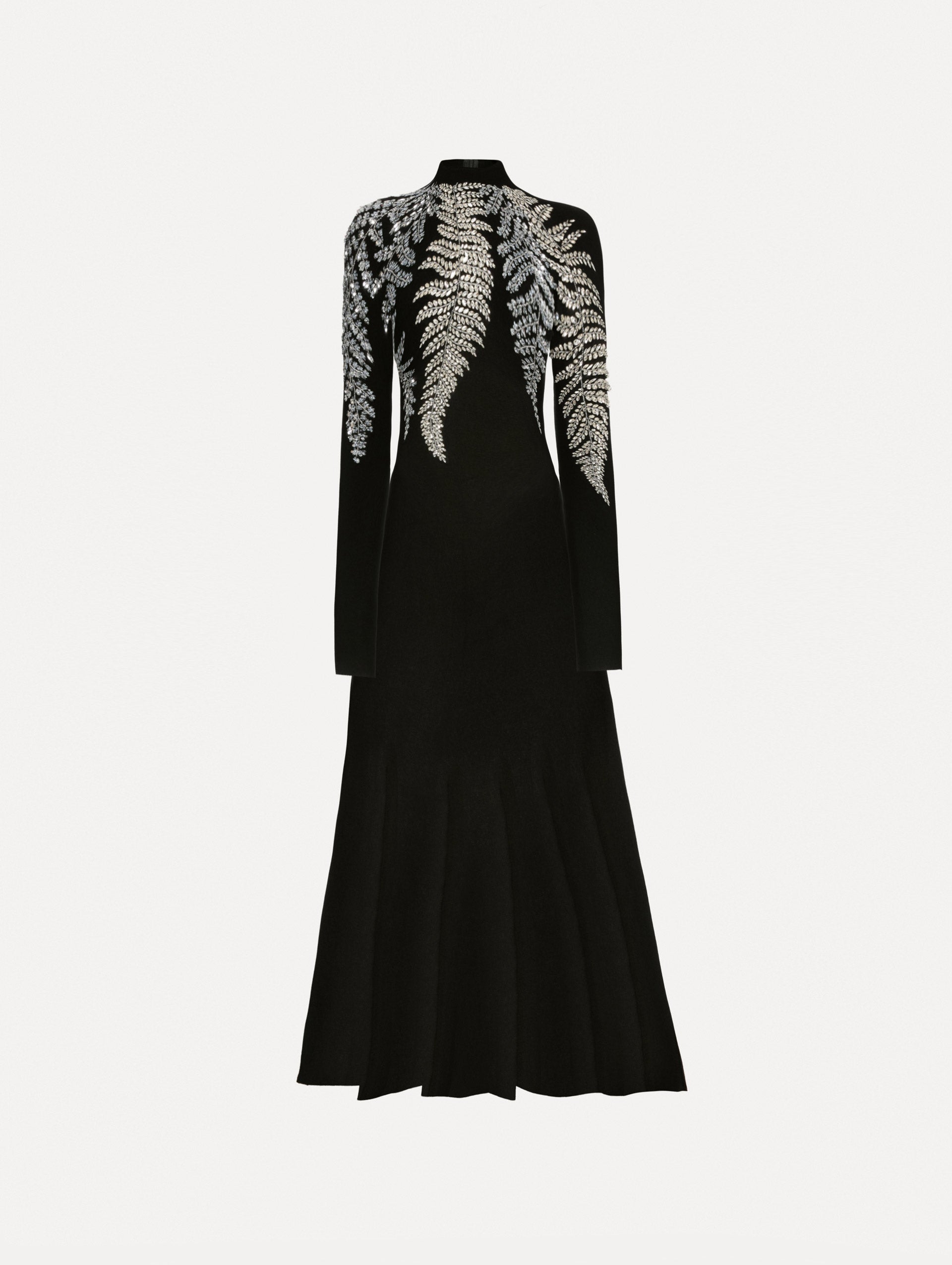 Black long sleeve dress with a mock neckline and flared skirt. Features metallic fern embroidery along neck and shoulders. 