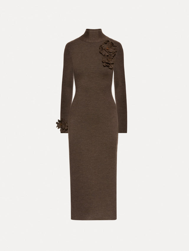 Long sleeve dark brown dress with a pencil silhouette and mock neckline. Tonal peony appliqués, with beaded detailing, frame the neckline and sleeves.