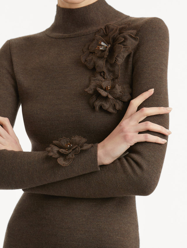 Zoomed in image of mock neckline with tonal peony appliqués, with beaded detailing, frame the neckline and long sleeves.