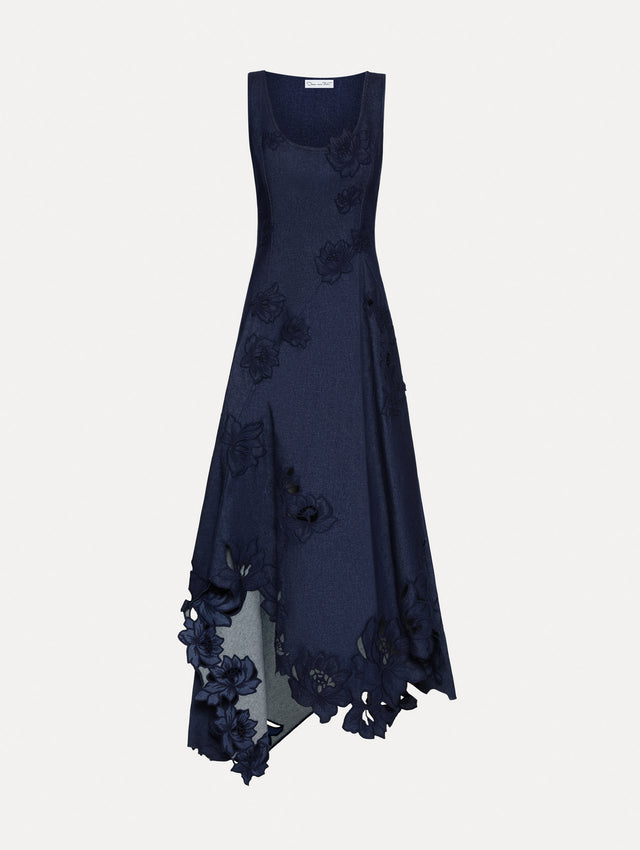 Denim dress with peony threadwork cutouts. Features a scoop neckline and a asymmetrical hem.
