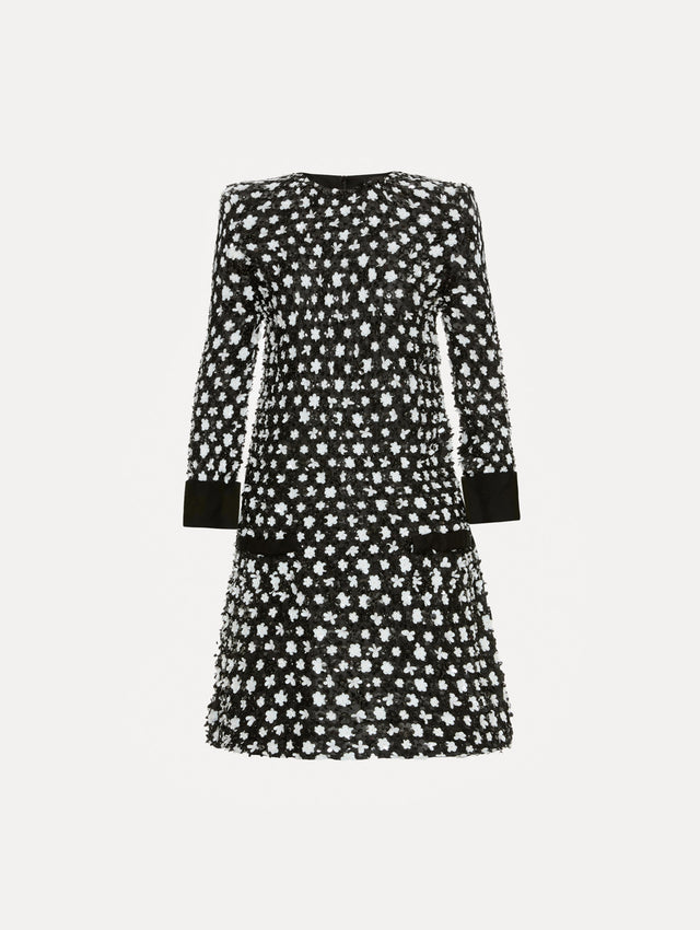 Dress with black and ivory floral sequin embroidery across the dress with three-quarter length sleeves. Features black cuffs and black non functional buttons.  