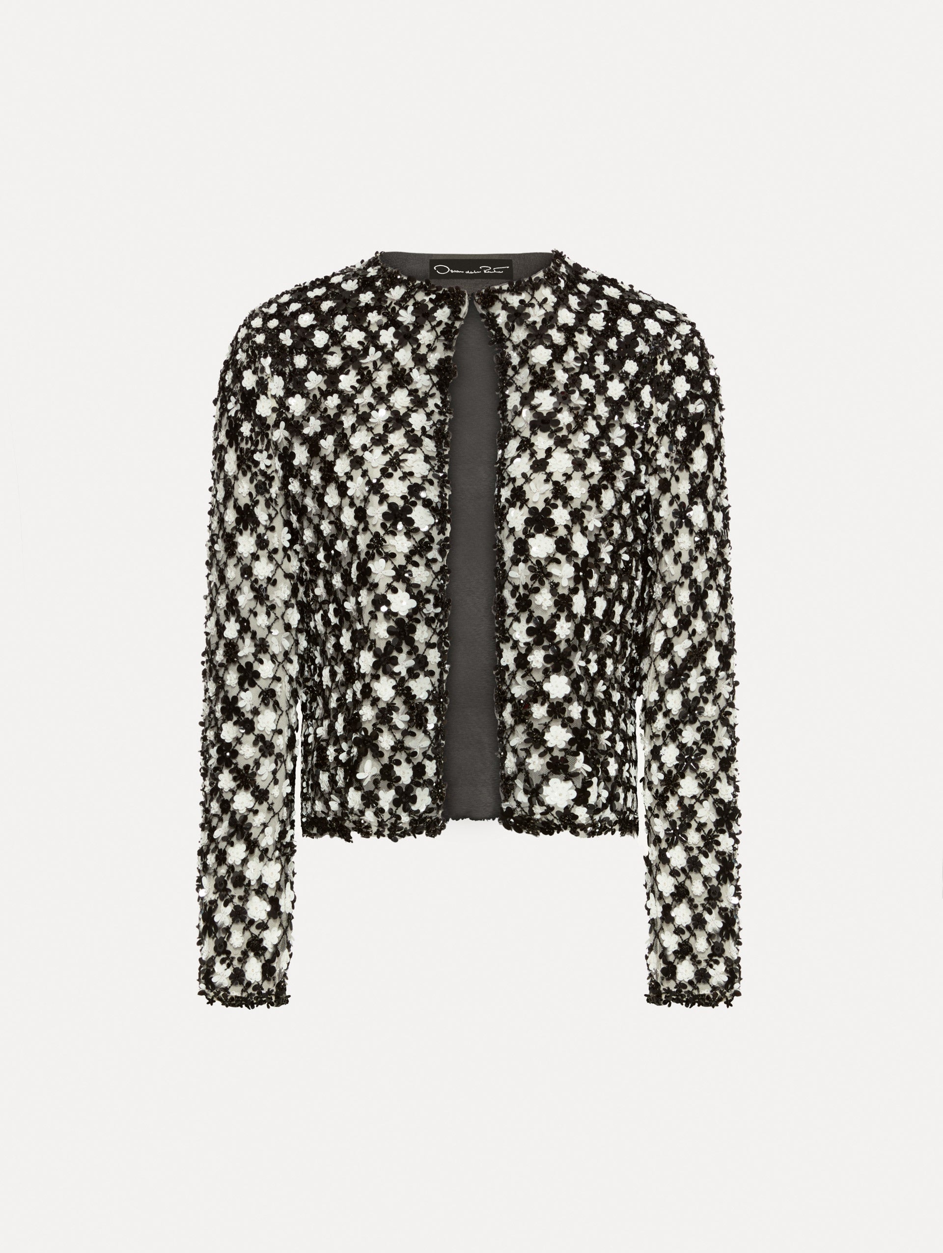 Black and ivory long sleeve jacket with sequin embroidery, where florets create a tweed pattern.