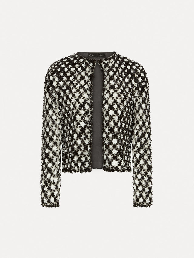 Black and ivory long sleeve jacket with sequin embroidery, where florets create a tweed pattern.