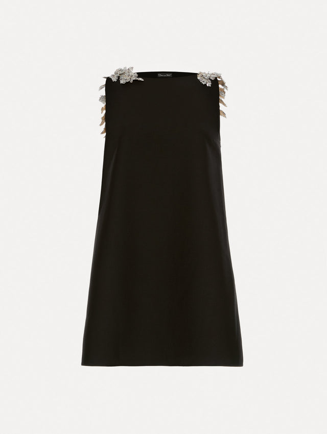 Black wool minidress in a shift silhouette that features silver sequin fern embroidery on the shoulders. 