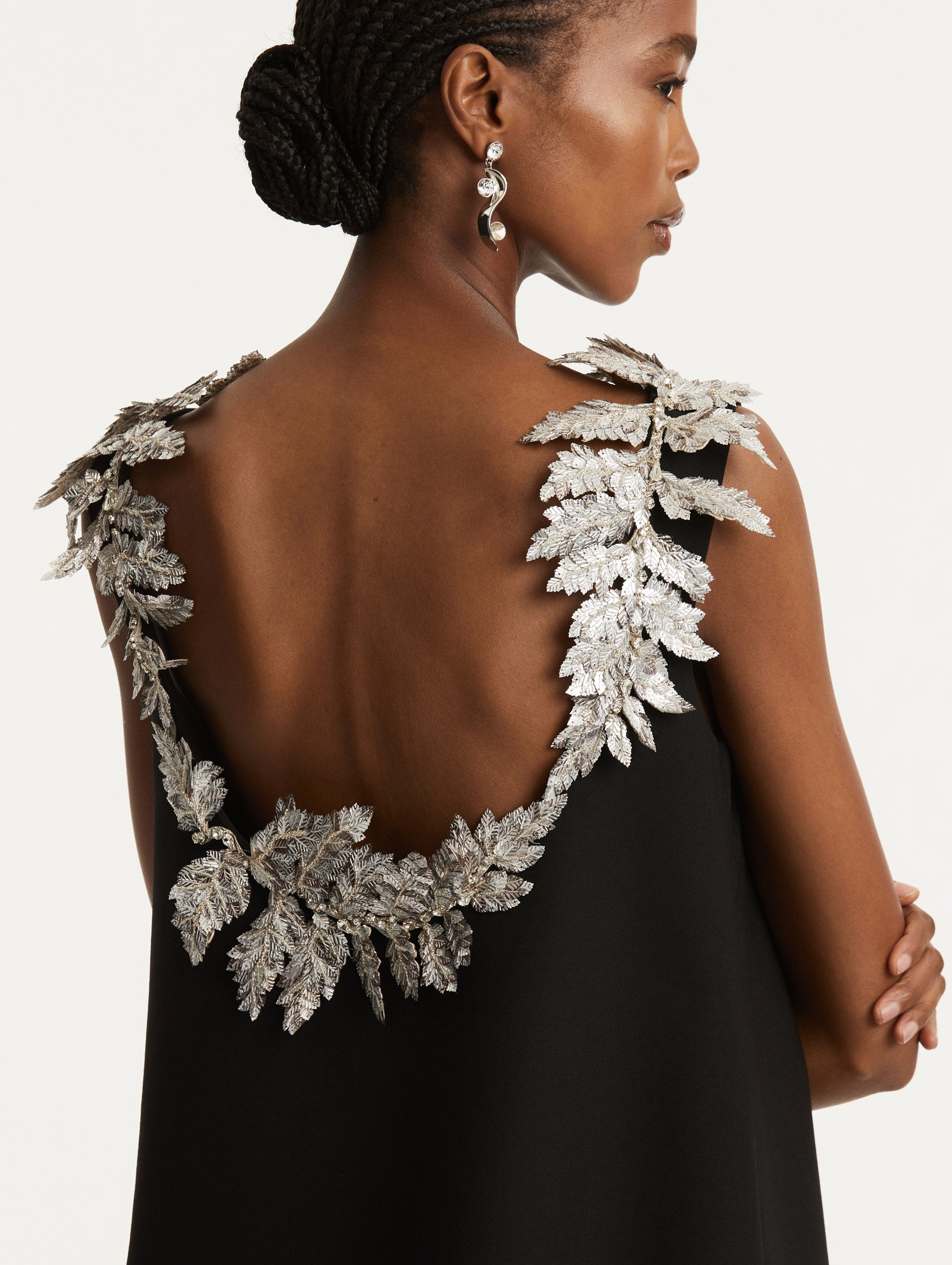 Zoomed in image of silver sequin fern embroidery following the scoop back. 