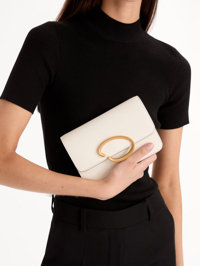 White O Pochette with Gold chain and abstract metal O clasp. Front View.