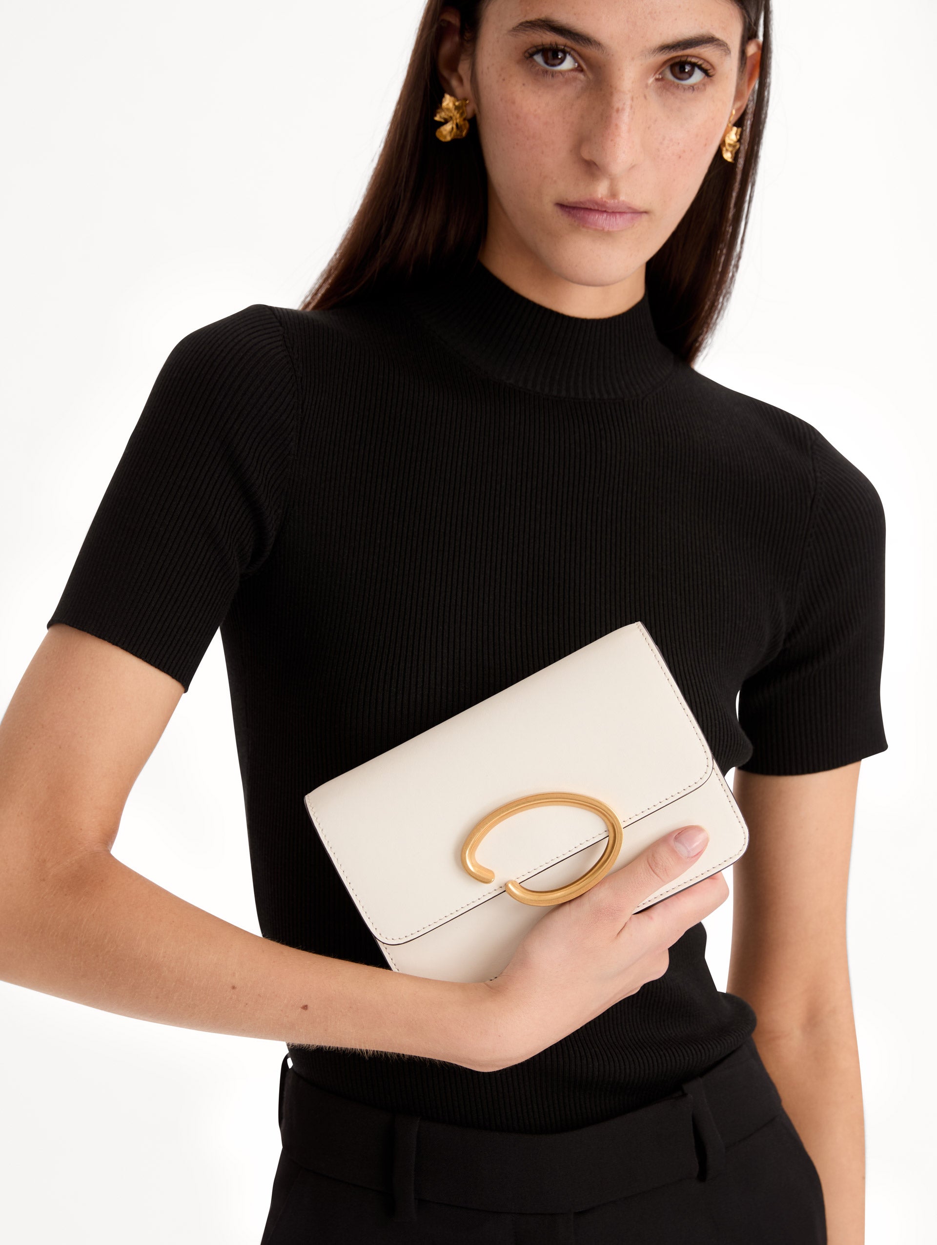 White O Pochette with Gold chain and abstract metal O clasp. Front View.