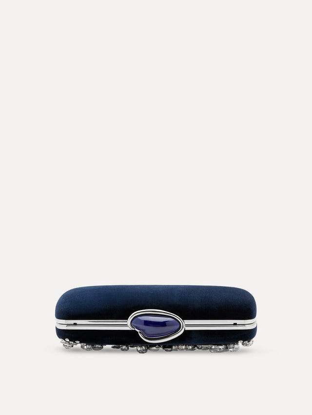 Flat view of clutch with multi-dimensional crystal embroidery and faceted stones scattered across the front canvas. The clutch features the Oscar ‘O’ emblem at the clasp. 