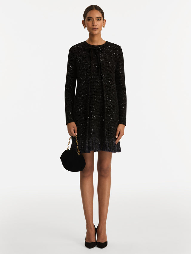 The Velvet Clutch in black features fabric folding, where the velvet is gathered and secured with a voluminous bow. 