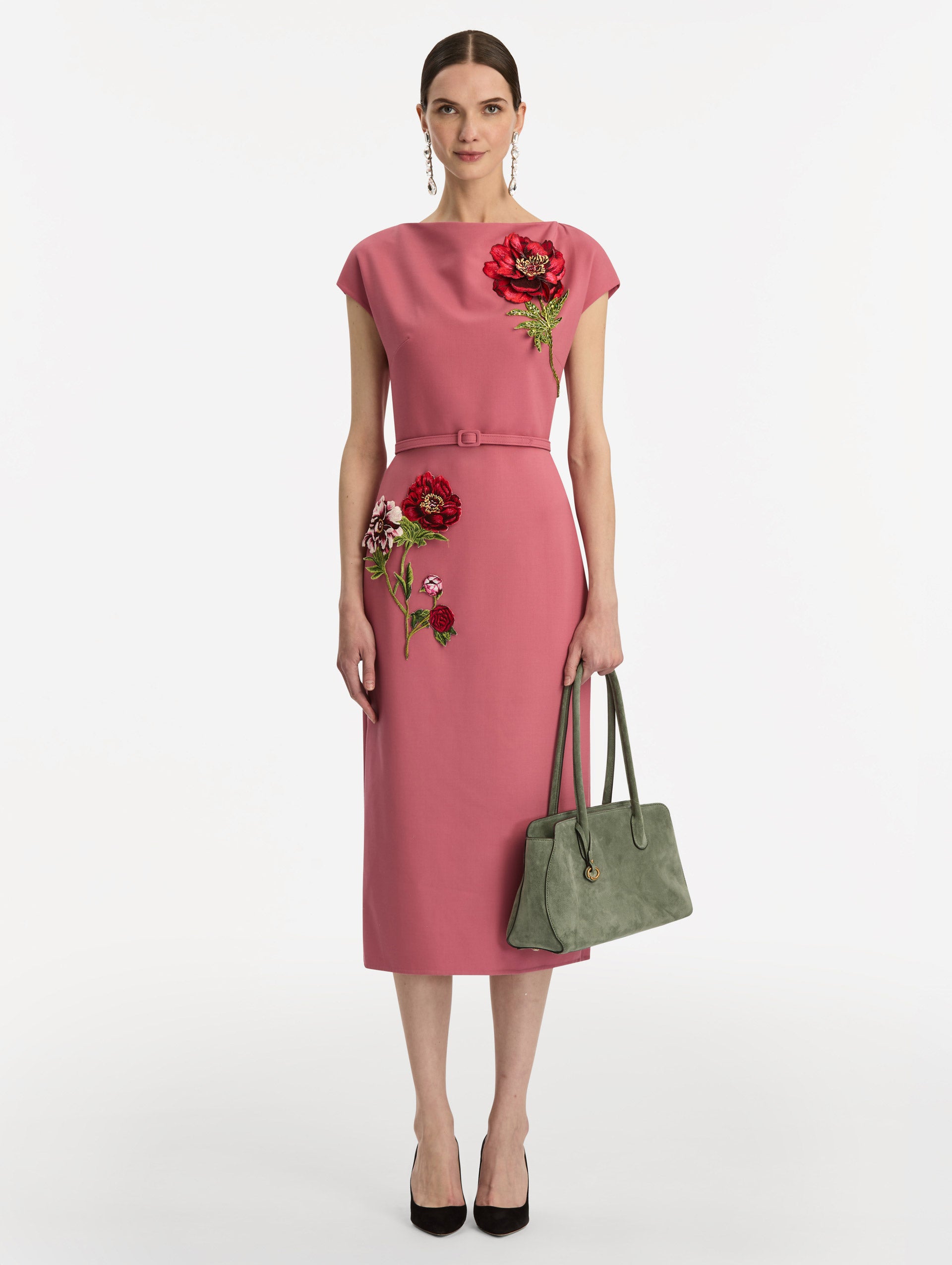 The Aster in sage has decisive lines and gently curved sides with the contours of the Oscar 'O.' Elongated top handles with gold hardware and an emblem-stamped tag.