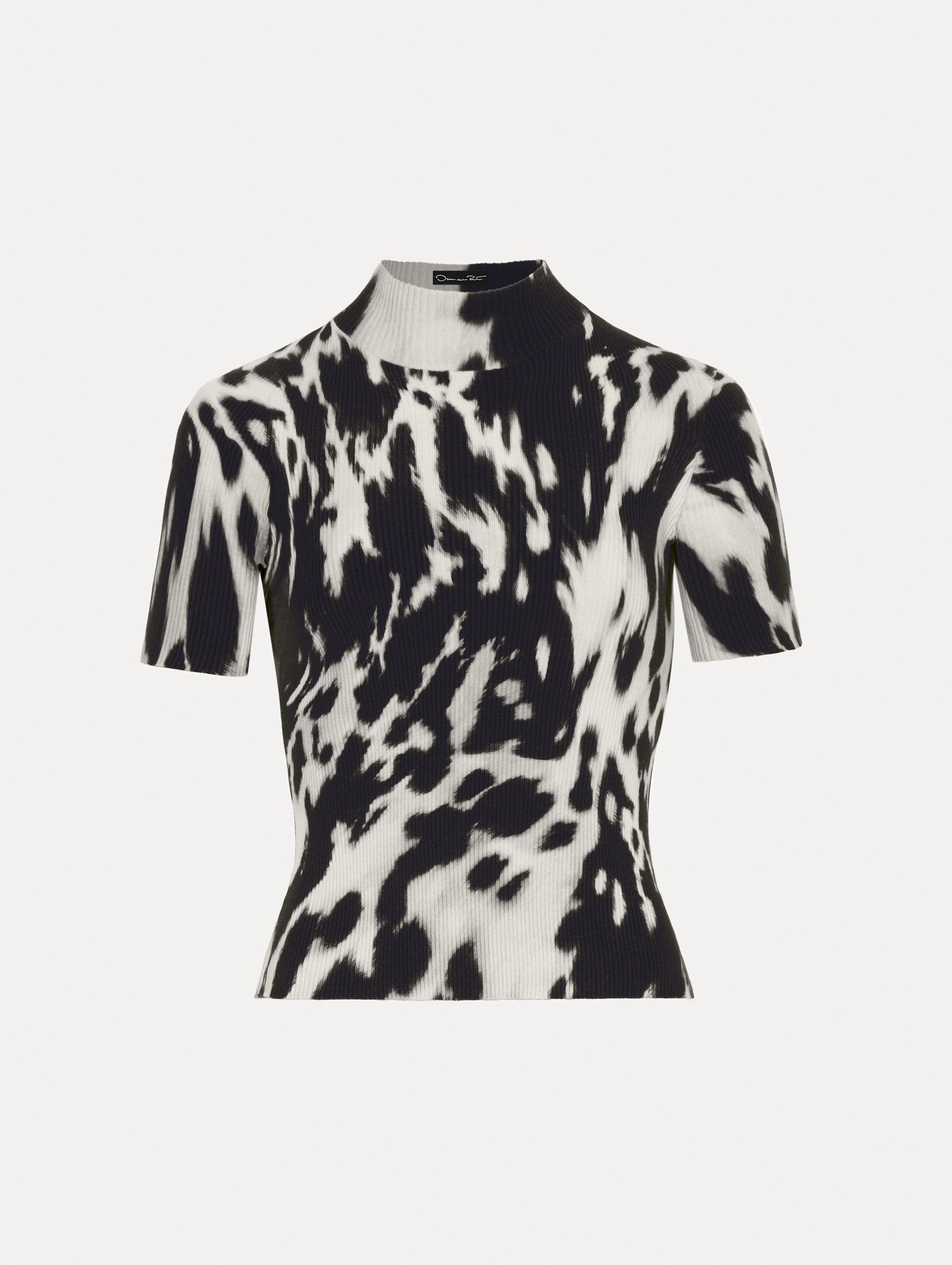 Short sleeve ribbed knit pullover with a mock neckline and cow print in ecru and black. 