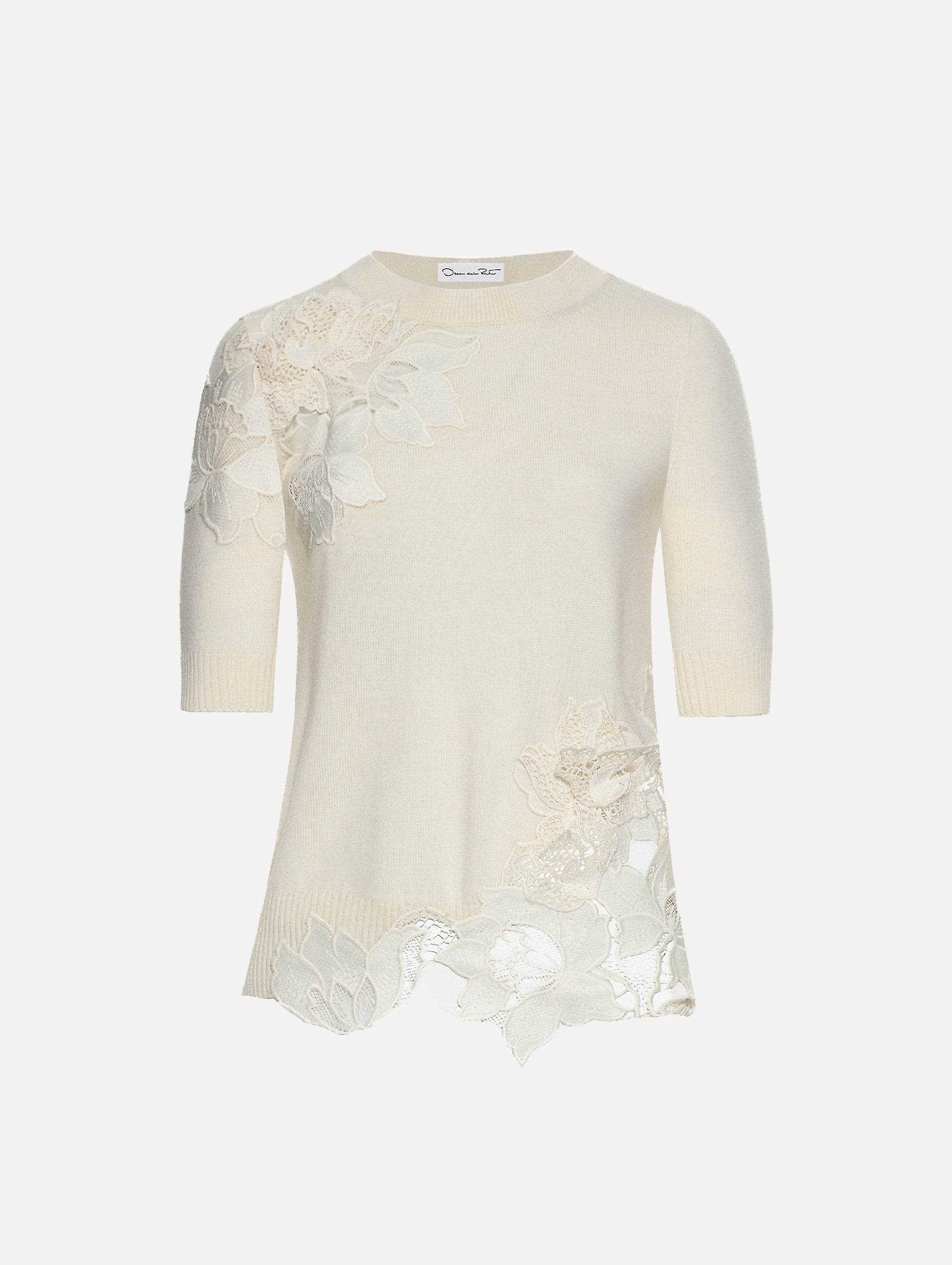 Ivory knit pullover with short sleeves and inserts of peony guipure lace.