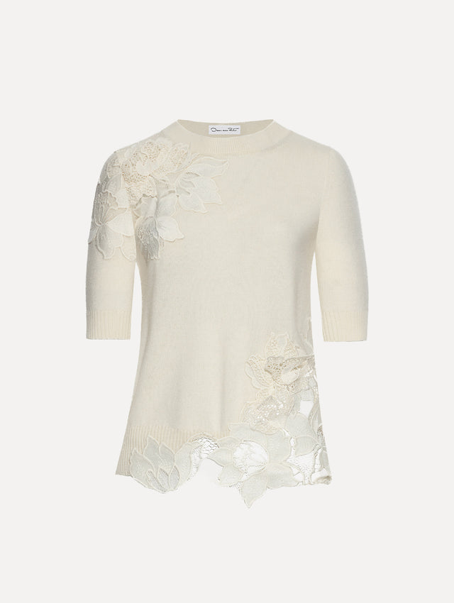 Ivory knit pullover with short sleeves and inserts of peony guipure lace.