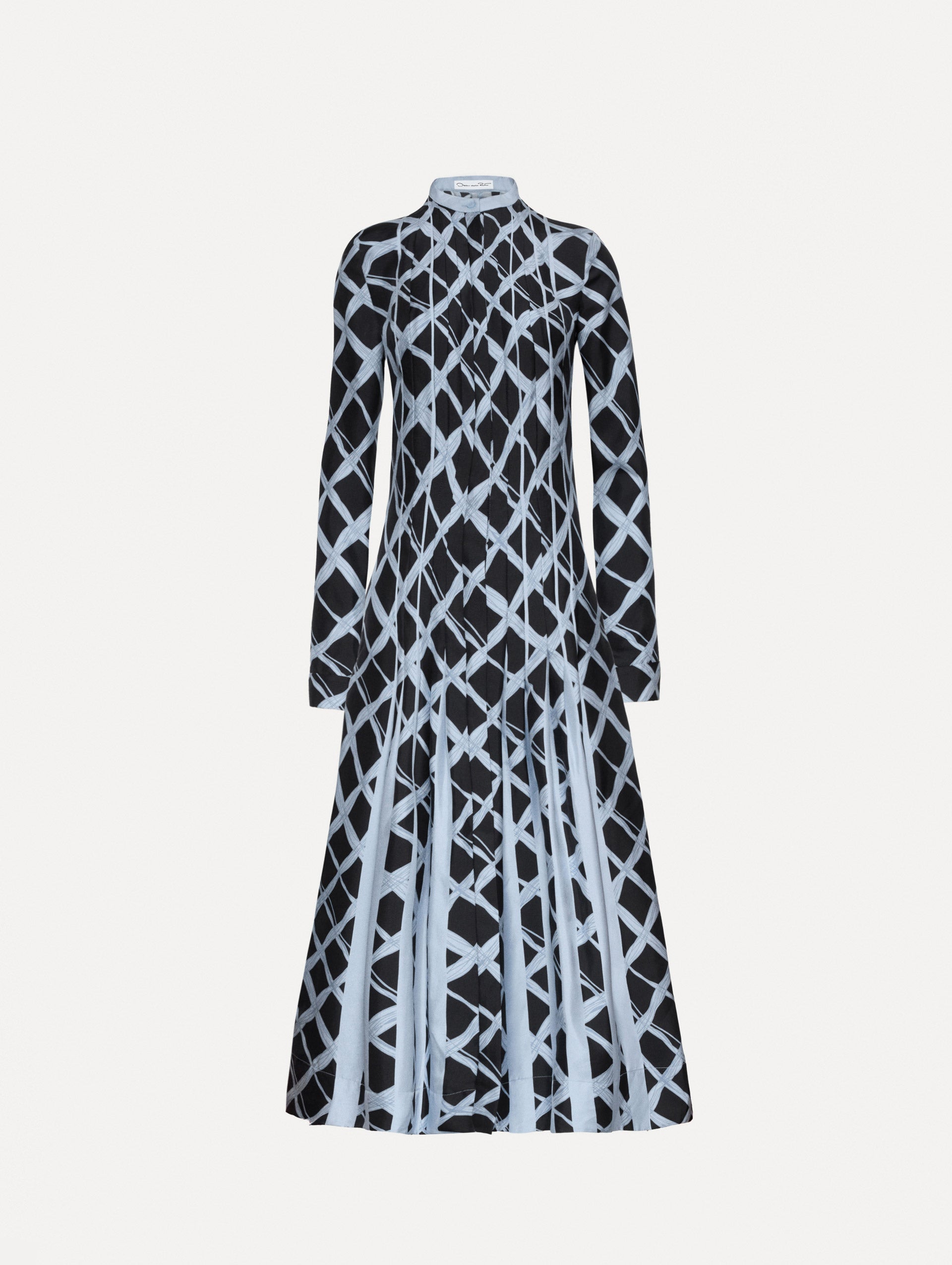 Long sleeve blue silk dress featuring a grid pattern, pleated bodice while the skirt falls to contrasting insets. 