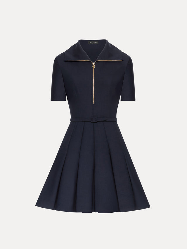 Navy short sleeve mini dress with gold zipper, spread collar, matching self-belt, and pleated skirt. 