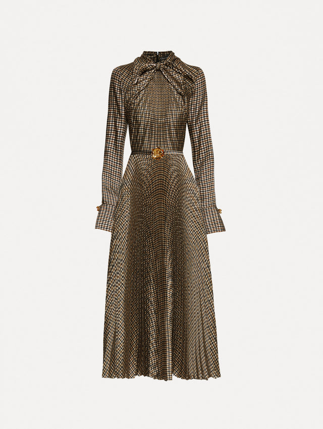 Multiple brown colored dress with a long sleeves and a neck tie. Dress also features pleating and a matching self-belt with a gold peony at the center. 