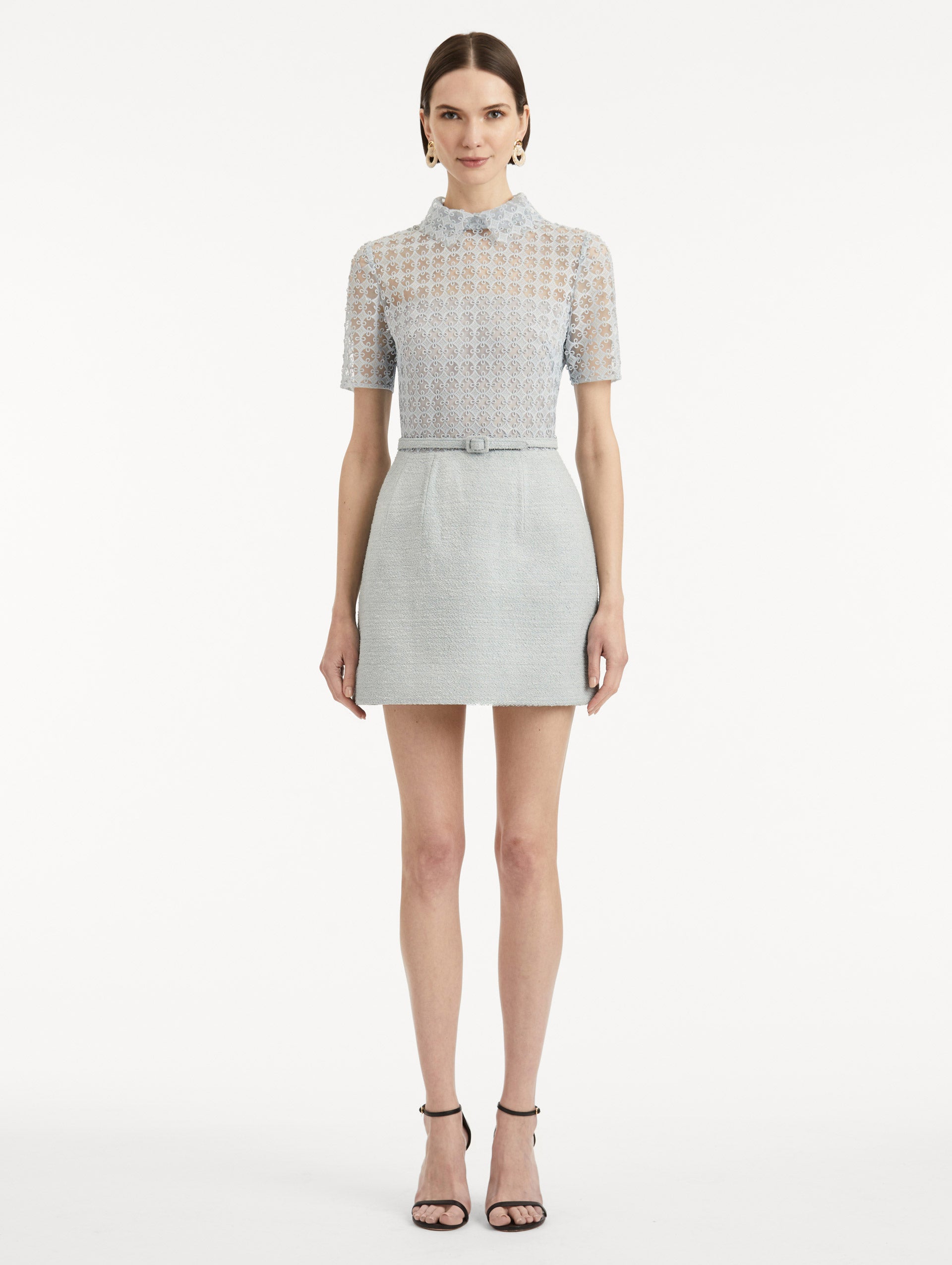 Full body front view image of model wearing blue quartz tweed dress with lace top, short sleeves, collar, and matching tweed belt. 