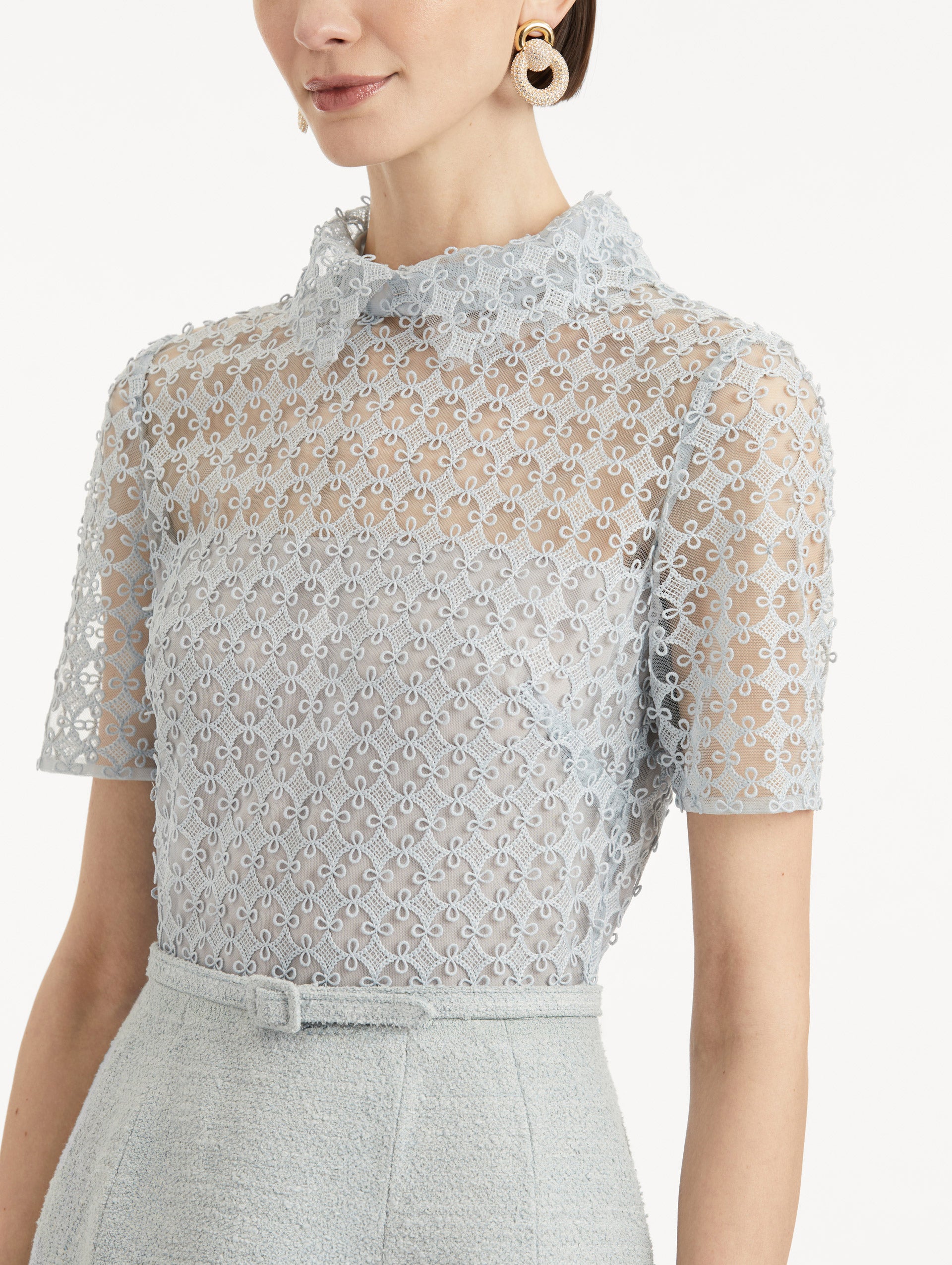 Zoomed in image of blue quartz lace top with collar and matching tweed belt. 