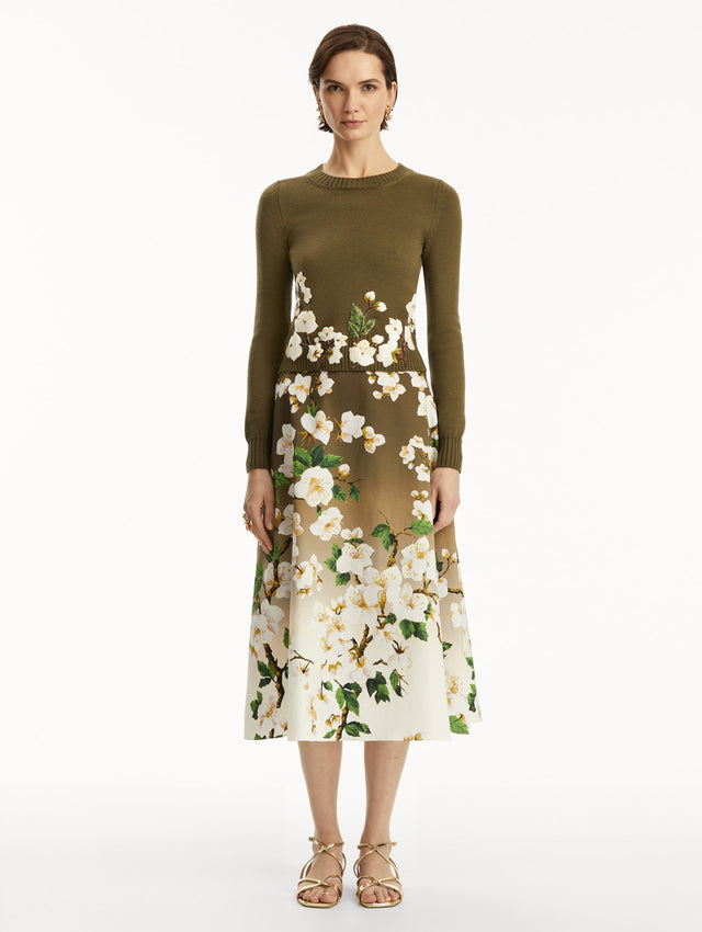 The model is wearing a Khaki pullover with white cherry blossoms embroidered in the bottom, over a matching dress. Front view