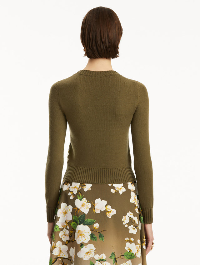 The model is wearing a Khaki pullover with white cherry blossoms embroidered in the bottom, over a matching dress. Back view