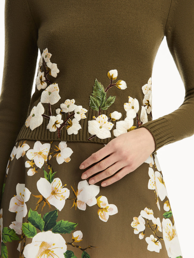 The model is wearing a Khaki pullover with white cherry blossoms embroidered in the bottom, over a matching dress. Zoom view