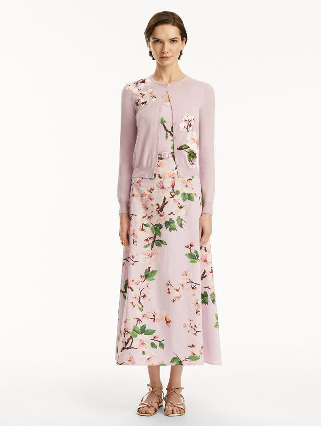 Model wearing lily cardigan with cherry blossom embroidery, paired with a cherry blossom dress. Front view