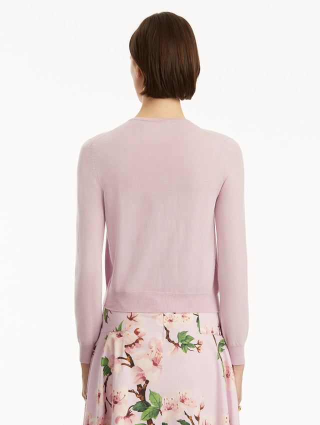 Model wearing lily cardigan with cherry blossom embroidery, paired with a cherry blossom dress. Back view