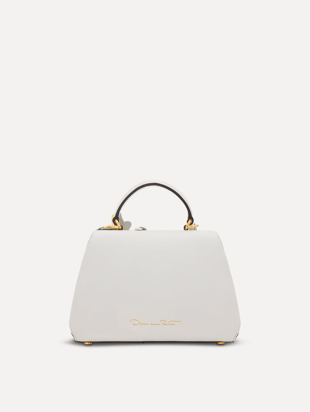 The Mini Poppy handbag in ivory with three-dimensional flowers attached. This bag comes with the Oscar O logo around the top handle, and a detachable shoulder strap. Back View.