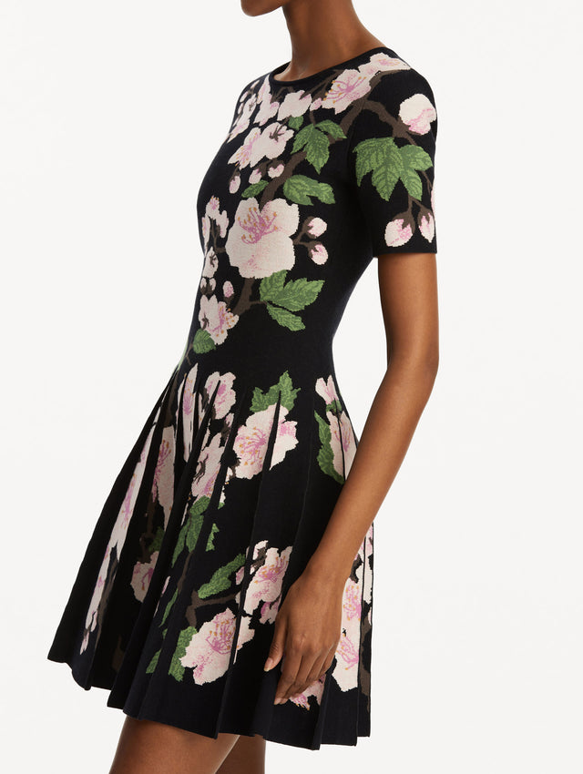 Zoomed in view of model wearing Cherry Blossom Pleated Jacquard Dress Side View.