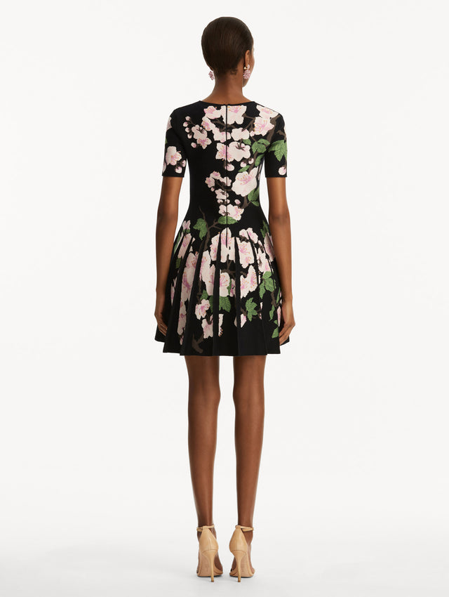 Model wearing Cherry Blossom Pleated Jacquard Dress Back View