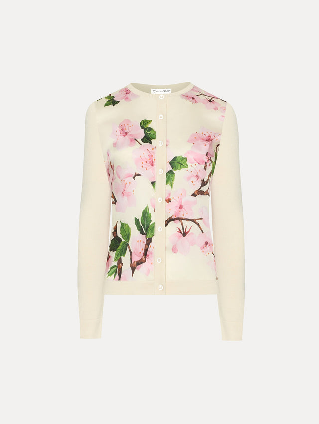 White cardigan with pink cherry blossoms.