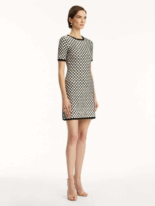 Black and white honeycomb print sequin knit short sleeve mini dress. Side view