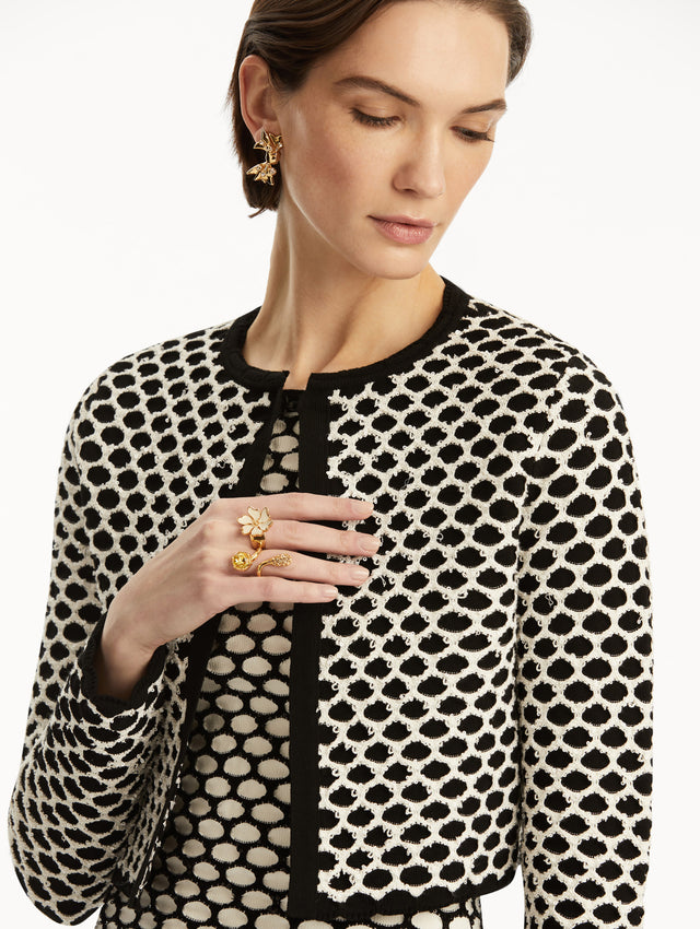 Model wearing black and white honeycomb print sequin knit jacket, paired with a matching dress. Zoom view