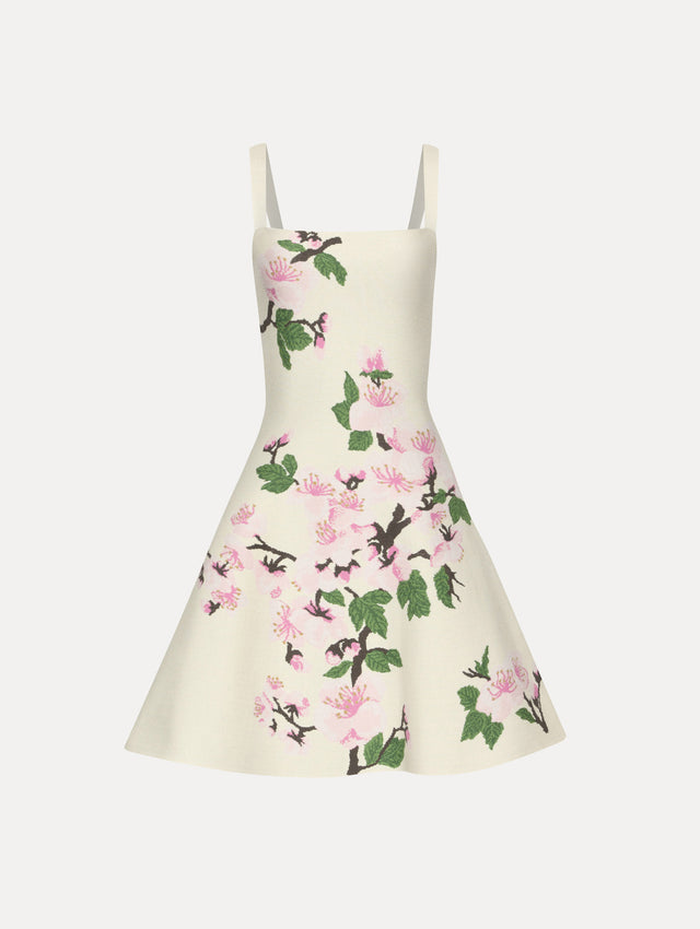 White knit mini jacquard sleeveless dress with pink cherry blossom print.