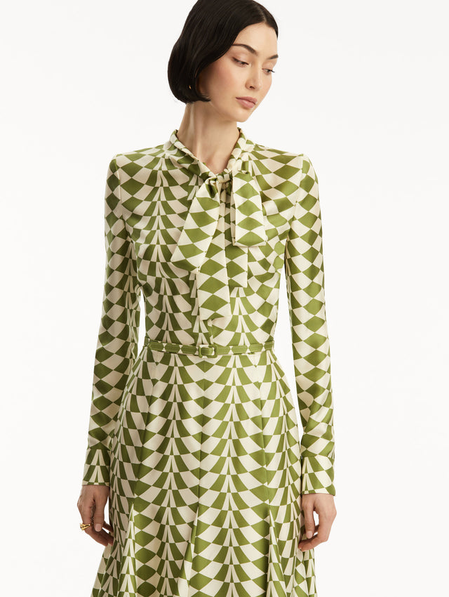 Long sleeve green and white geometric print silk midi dress with tie detail around the neck. Zoom view