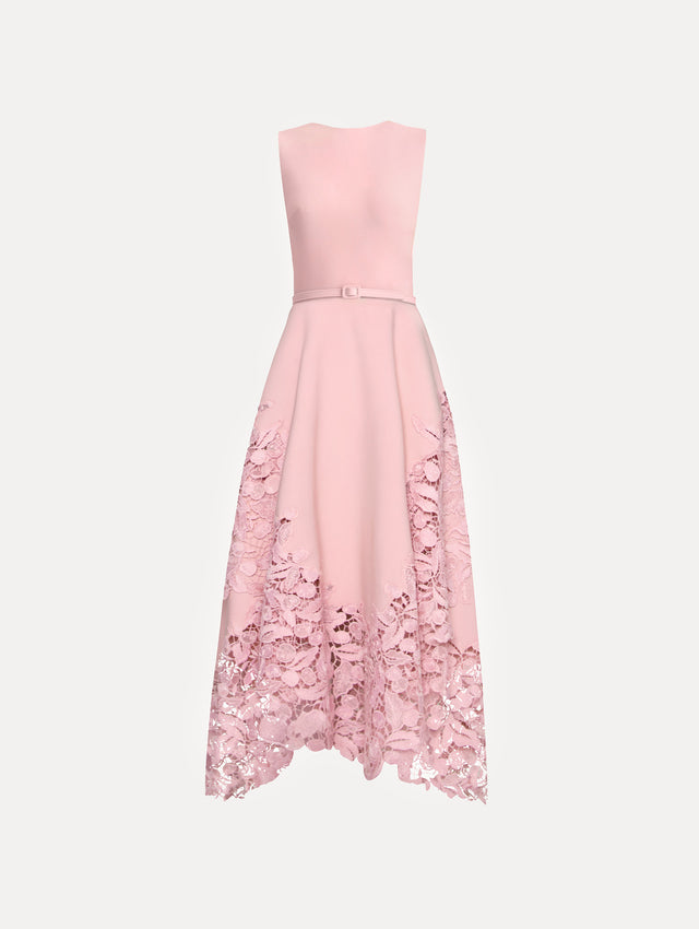 Sleeveless light pink dress with lace detail in the bottom and pink belt around the waist.