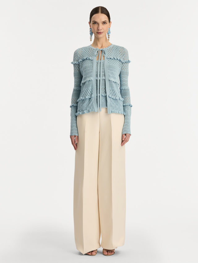Light Blue Scallop Trim Cardigan with tie closure and textured knit patterning. Front View.
