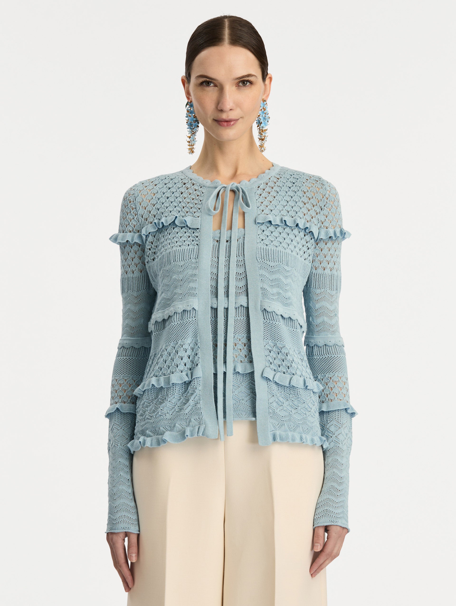 Light Blue Scallop Trim Cardigan with tie closure and textured knit patterning. Front View.