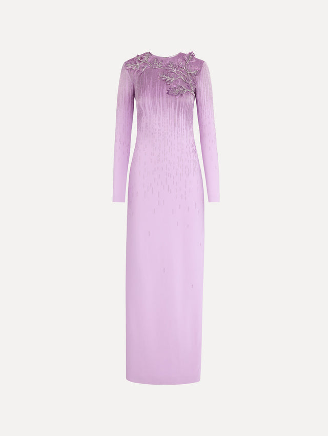 The model is wearing the intarsia leaves cutout embroidered gown with long sleeves in the color verbena.