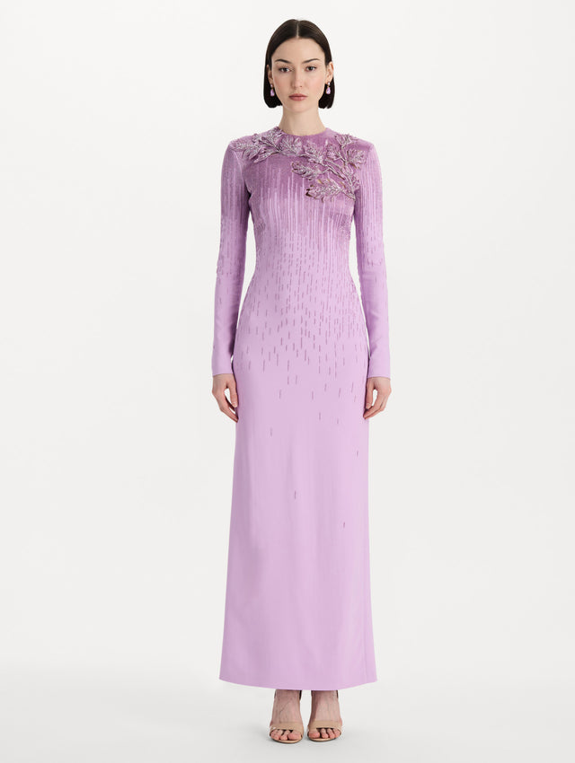 The model is wearing the intarsia leaves cutout embroidered gown with long sleeves in the color verbena. Front view. 