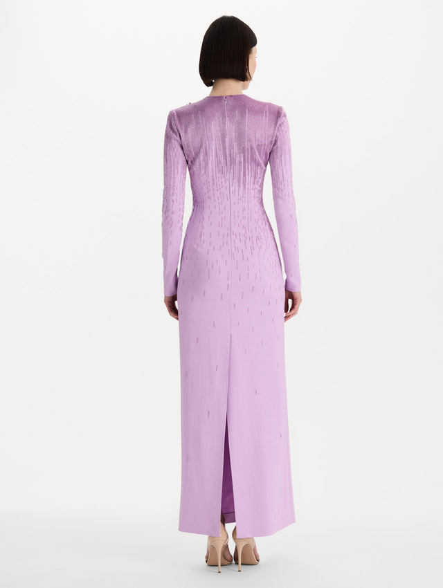 The model is wearing the intarsia leaves cutout embroidered gown with long sleeves in the color verbena. Back view. 