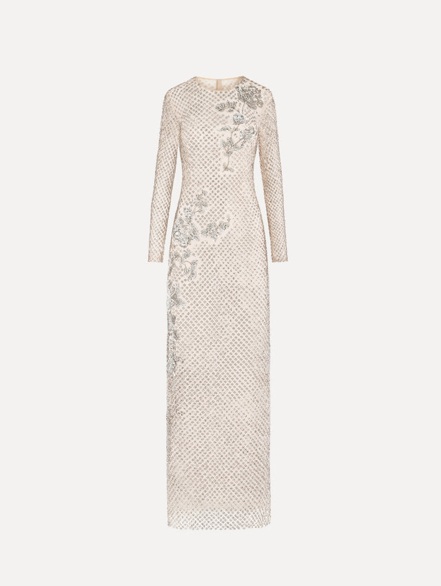 The model is wearing the crystal grid floral embroidered gown with long sleeves in the color silver.