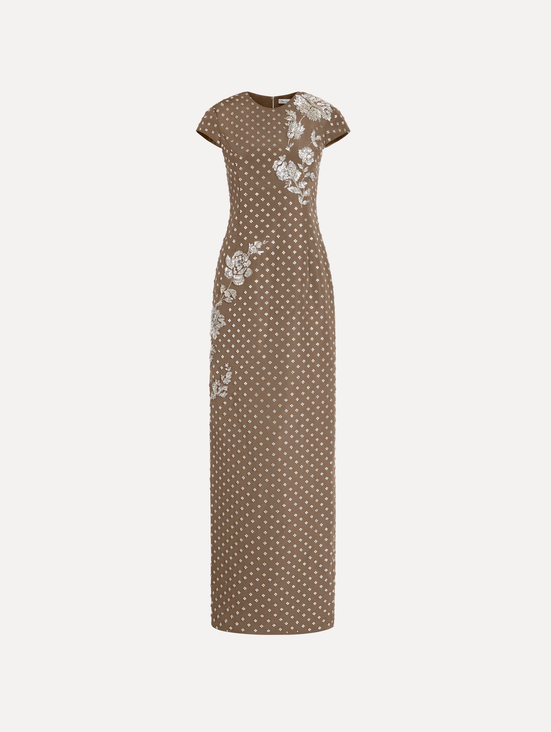 The model is wearing the crystal grid floral embroidered gown with short sleeves in the color stone.